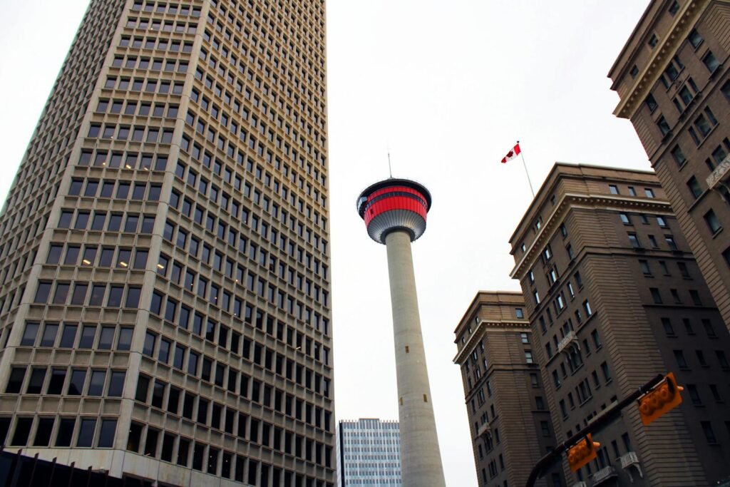 Low angle shot of Calgary Tower with urban buildings in downtown Calgary, Canada.